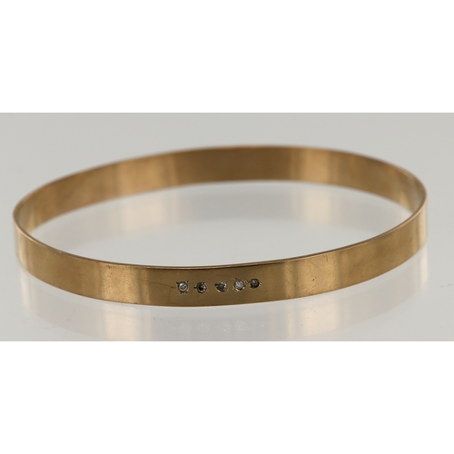 632 - Yellow gold (tests 9ct) solid bangle, set with five diamonds, TDW approx. 0.04ct, flat profile width... 