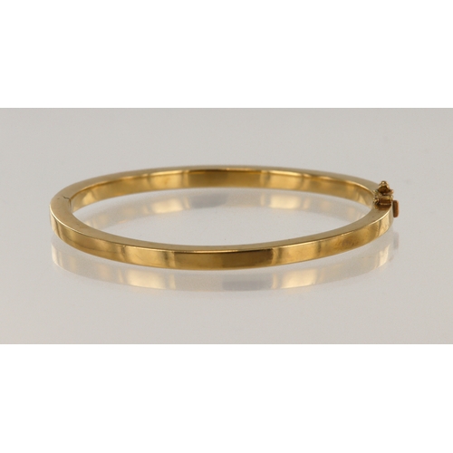 646 - Yellow gold (tests 9ct) hinged bangle, 4mm wide with a square profile, inside diameter 59mm x 57mm, ... 