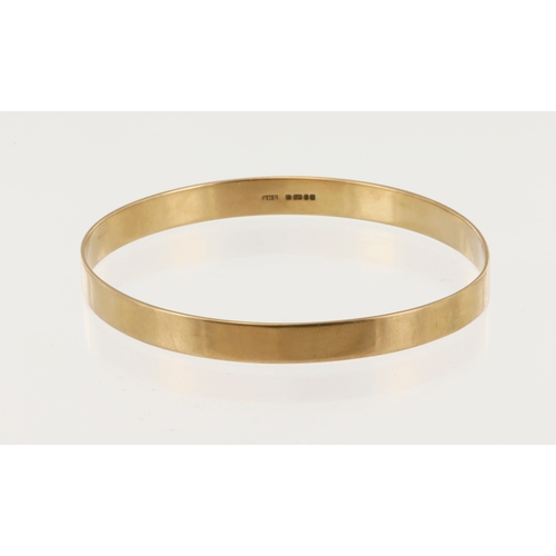 647 - 9ct yellow gold solid bangle, flat profile width 6mm, inside measures 59mm x 65mm, weight 13.1g.