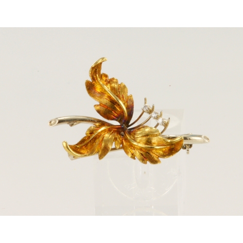 648 - 18ct yellow and white gold foliate brooch, set with three CZs, brooch length 40mm, weight 6.1g.