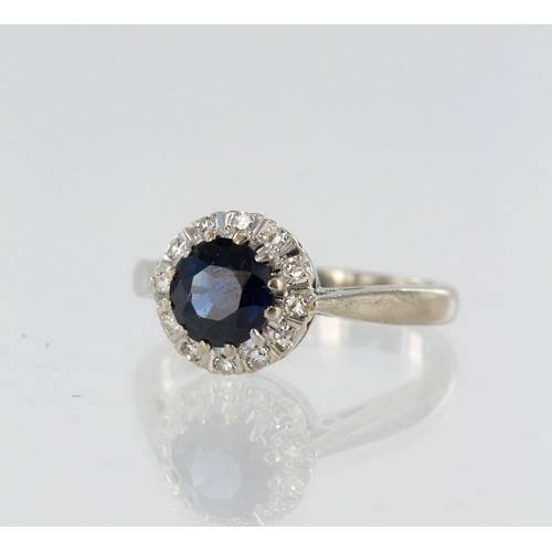 81 - White gold (tests 18ct) diamond and teal sapphire cluster ring, one round sapphire measures 5mm, sur... 