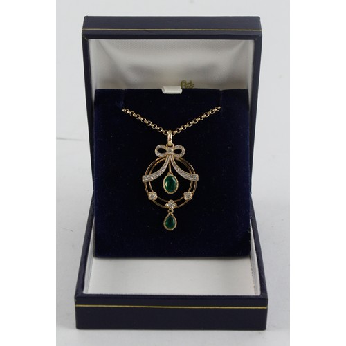 654 - 9ct yellow gold diamond and emerald ribbon necklet, two articulated emeralds, principle emerald meas... 