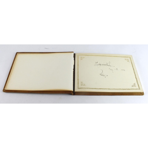 380 - Queen Elizabeth & Prince Philip. A leather bound vistors book signed at the front in ink by Queen El... 