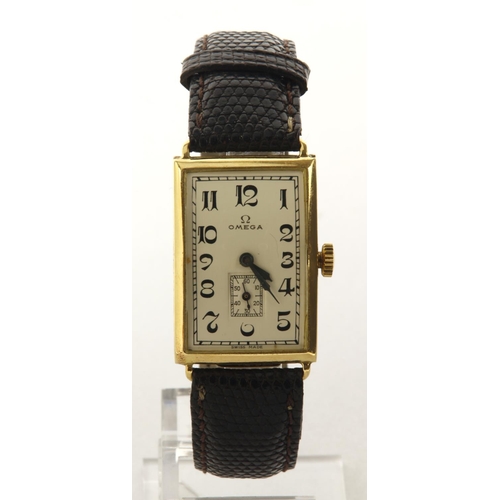 18 - Gents 18ct cased Omega manual wind wristwatch, circa 1923. The silvered dial with Arabic numerals, b... 