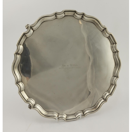 383 - Large silver pie-crust salver on four ball feet - front reads 