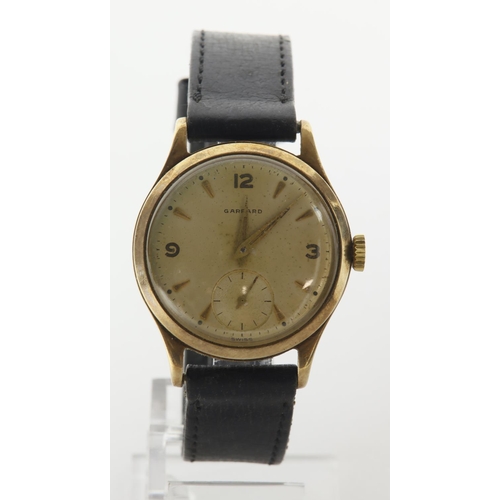 67 - Gents 9ct cased Garrard manual wind wristwatch, hallmarked Birmingham 1958. Patina dial with Arabic ... 