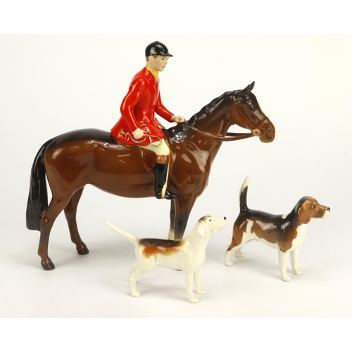 81 - Beswick Huntsman on a horse (no. 1501), with two hounds, huntsman figure height 20cm approx.