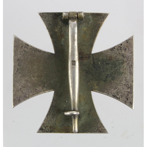 1113 - German Iron Cross 1st class pin back, a one piece private purchase or naval issue, in an old tin.