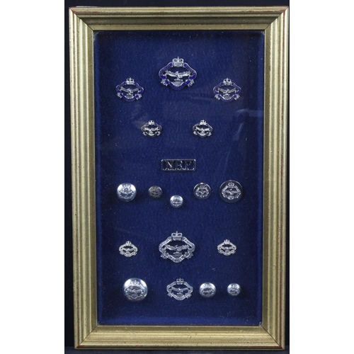 323 - Northern Rhodesian glazed & framed collection of QE2 era badges and buttons, including chromed and b... 