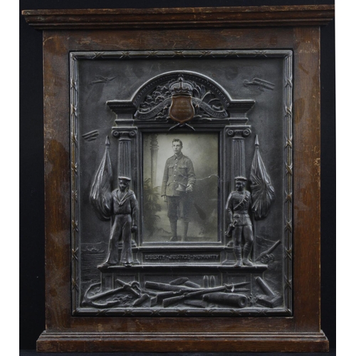 541 - WWI bronzed plaster memorial plaque, contained in an oak frame, with central photograph and shield a... 