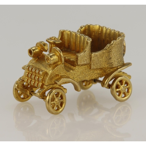 387 - 9ct yellow gold articulated vintage car charm, height 15mm, weight 7.9g.