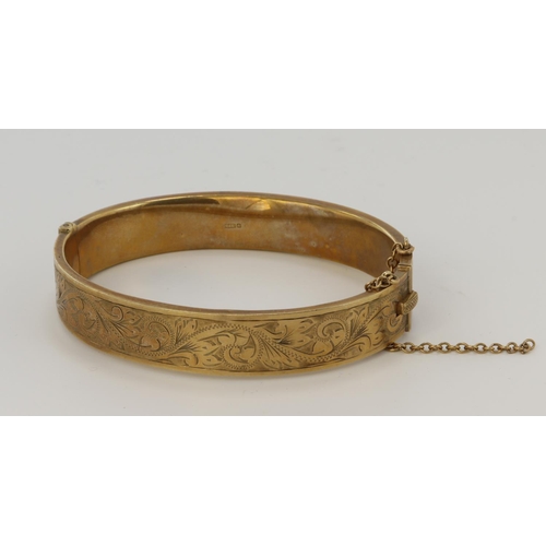 467 - 9ct yellow gold vintage bangle, front engraved with foliate and scroll details, bangle width approx.... 