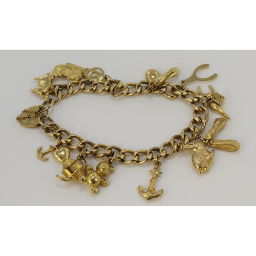 484 - 9ct yellow gold charm bracelet with heart padlock clasp, thirteen charms attached, bracelet length 7... 