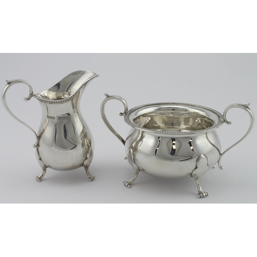 820 - Silver three piece teaset comprising teapot (with wooden handle) cream jug & sugar bowl, all hallmar... 