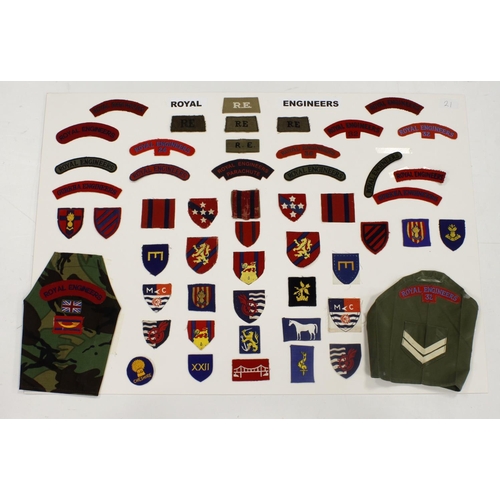 309 - Display Board: Royal Engineers WW1, WW2 and later shoulder titles, formation signs, and brassards, a... 