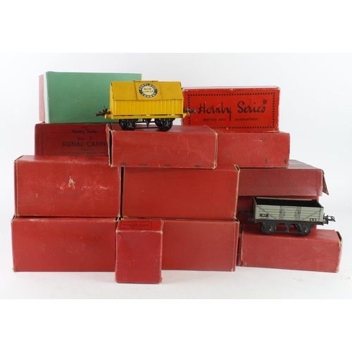 308 - O Gauge. A collection of approximately thirty-two boxed Hornby O gauge model railway, including wago... 