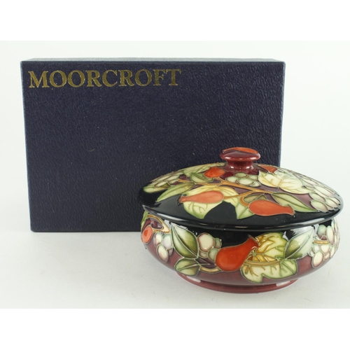 439 - Moorcroft Winter Harvest pattern lidded bowl, diameter 12.5cm approx., contained in a Moorcroft box