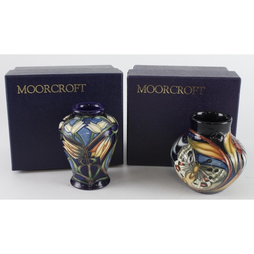 445 - Moorcroft. Two small Moorcroft vases, tallest 90mm approx., both contained in Moorcroft boxes