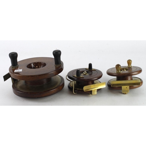 577 - Fishing Reels. Three wooden fishing reels with brass mounts, including one stamped 'A. W. Gamage', l... 