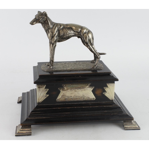 581 - Greyhound interest. A large greyhound art deco trophy with hinged lid, with unengraved plaquest, rai... 