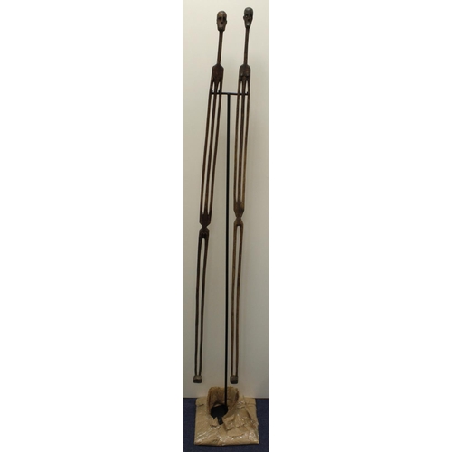 603 - Pair of S.African hand-carved, elongated  male and female figurines. Hung on a purpose made stand. H... 