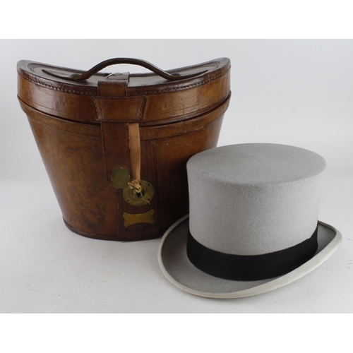 626 - Top Hat. A grey top hat by Woodrow, Piccadilly, contained in contemporary leather hat box, head size... 