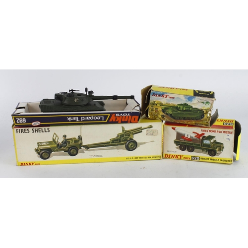 93 - Dinky Toys. Four Dinky Military models, comprising US Jeep with 105mm Howitzer (no. 615); Berliet Mi... 