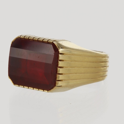 103 - 14ct yellow gold signet style ring set with a rectangular 13.5mm x 11.5mm barrel cut red paste stone... 