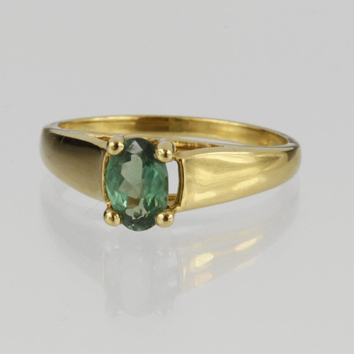 105 - 18ct yellow gold ring set with a single oval green tourmaline measuring approx. 6mm x 5mm, finger si... 