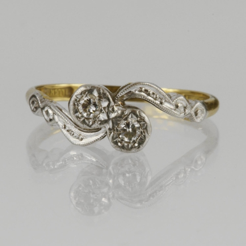 109 - 18ct yellow gold and platinum two stone crossover ring set with two round brilliant cut diamonds in ... 