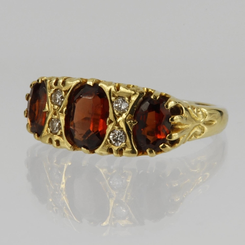 110 - 18ct yellow gold ring set with three graduated oval garnets, centre stone measuring approx. 7mm x 5m... 