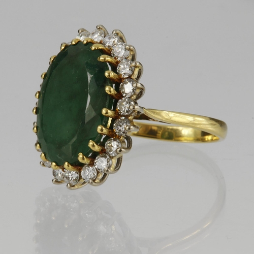 121 - 18ct yellow gold cluster ring set with central oval emerald measuring approx. 15mm x 12mm, surrounde... 