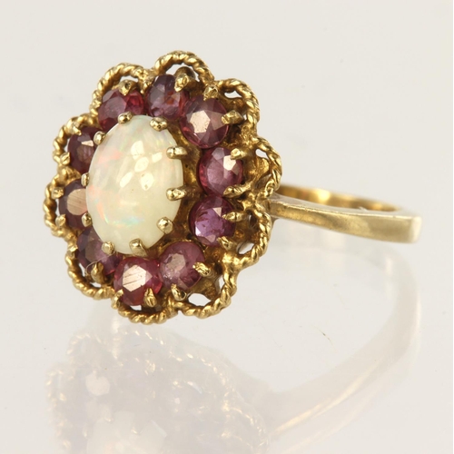 125 - 9ct yellow gold cluster ring set with central oval opal cabochon measuring approx. 8mm x 6mm, surrou... 