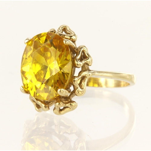 131 - 9ct yellow gold ring set with oval yellow cz measuring approx. 14mm x 11mm, finger size M. weight 6.... 