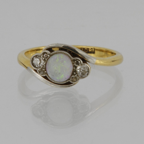 139 - 18ct yellow gold and platinum crossover style ring set with a central round opal cabochon measuring ... 