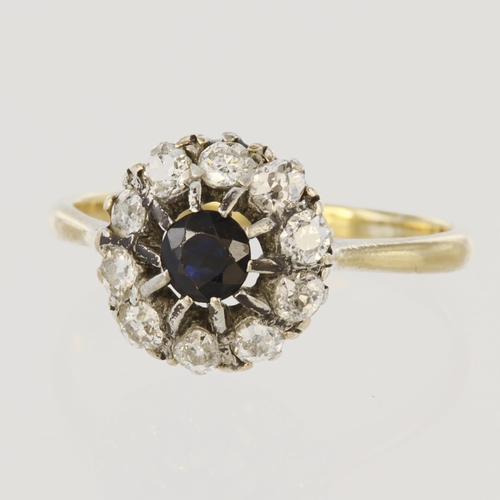 146 - 18ct yellow gold cluster ring set with central round sapphire measuring approx. 4mm diameter, surrou... 