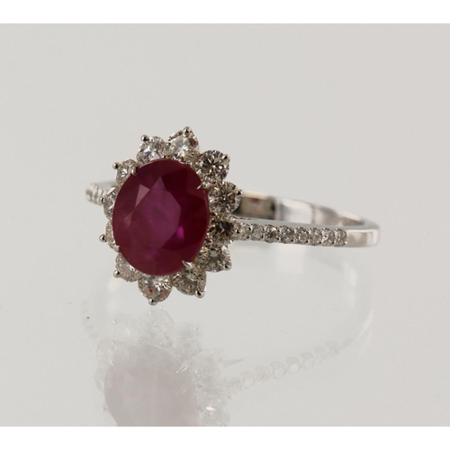 169 - White gold (tests 18ct) diamond and ruby cluster ring, one oval ruby approx. 1.50ct, surrounded by d... 