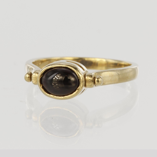 175 - 9ct yellow gold ring with swivel head to display garnet cabochon one side and lapis cabochon the oth... 