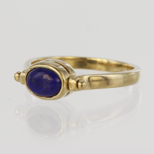 175 - 9ct yellow gold ring with swivel head to display garnet cabochon one side and lapis cabochon the oth... 