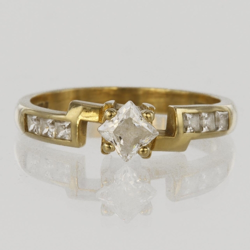 195 - 14ct yellow gold ring set with a square cz in four claw mount with a further square cz to each shoul... 