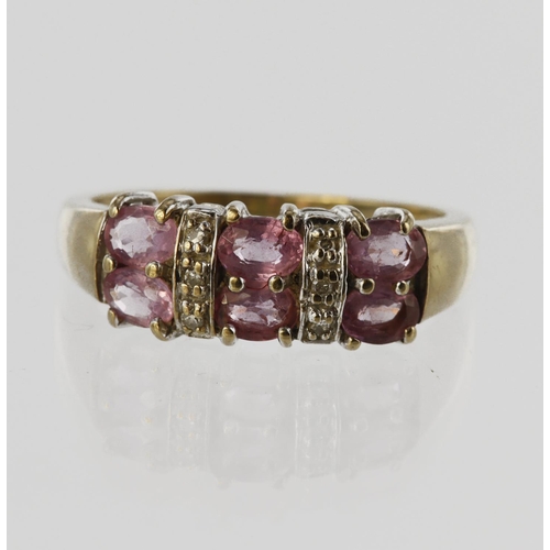 22 - 9ct yellow gold two row band ring set with six oval pink sapphires spaced by six diamond accents, fi... 