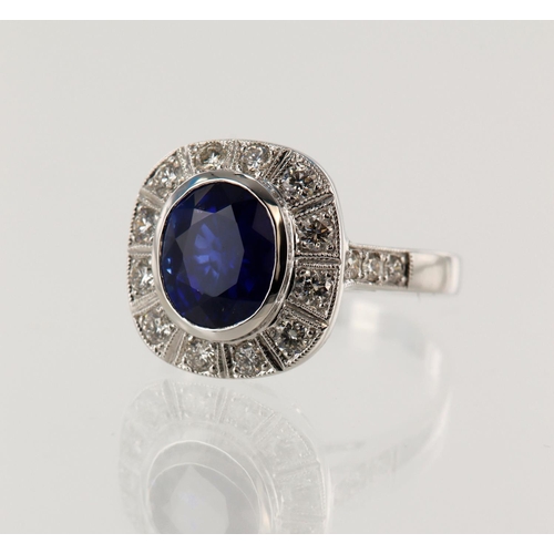 37 - White gold (tests 18ct) diamond and sapphire cluster ring, oval sapphire measures approx.10mm x 8mm,... 