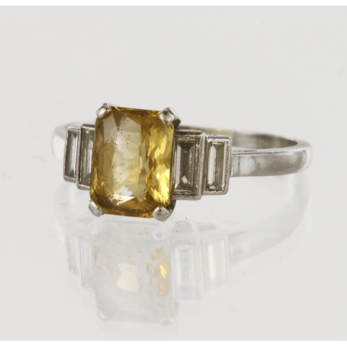 38 - Tests as platinum five stone dress ring featuring central cushion cut yellow sapphire measuring appr... 