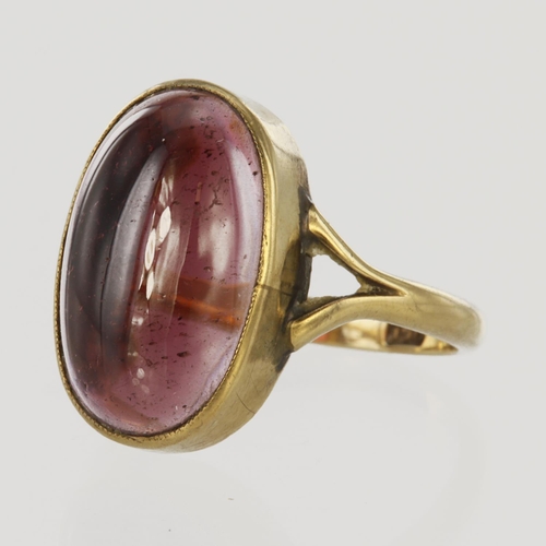 40 - 9ct yellow gold ring set with single oval pink tourmaline measuring approx. 17.5mm x 11.5mm in a rub... 