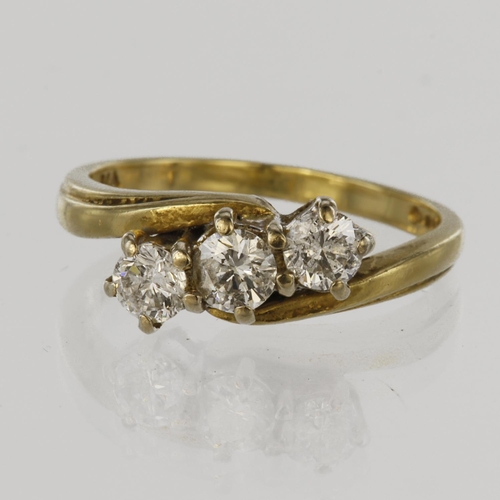 42 - 18ct yellow gold trilogy crossover style ring set with three round brilliant cut diamonds, total dia... 