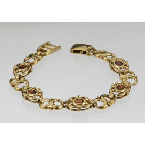 492 - 9ct yellow gold garnet bracelet, set with five oval garnets approx. 5.5 x 4mm, 7.5