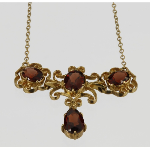 496 - 9ct yellow gold necklace set with three oval garnets measuring approx. 8mm x 6mm, and two 7mm x 5mm,... 