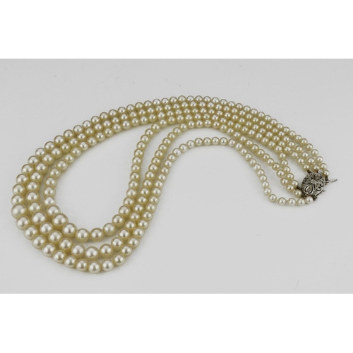 499 - Three row graduated cultured pearl necklace, strun onto a 9ct white gold diamond set box clasp with ... 