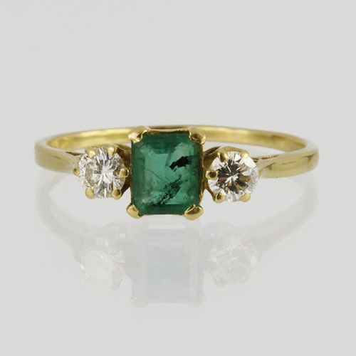 57 - 18ct yellow gold three stone ring featuring central rectangular step cut emerald measuring approx. 5... 