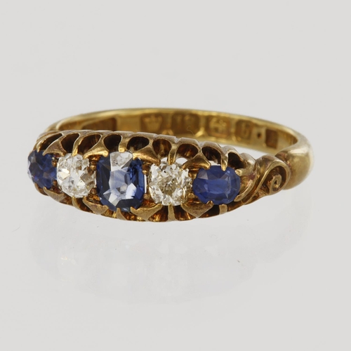 61 - 18ct yellow gold five stone ring, featuring a central cushion shaped sapphire measuring approx. 4mm ... 